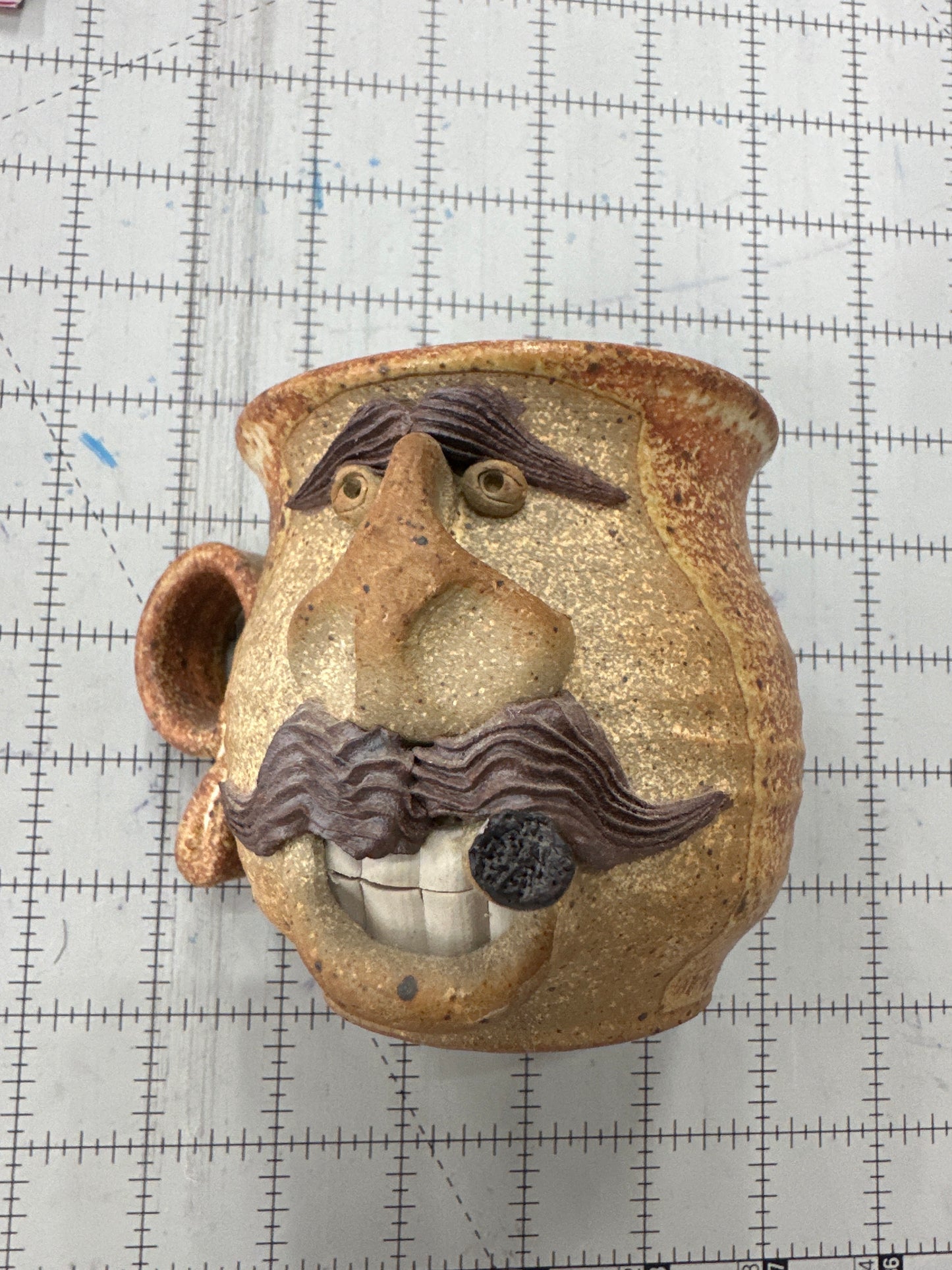 Vintage folk art “ugly face” pottery mug
