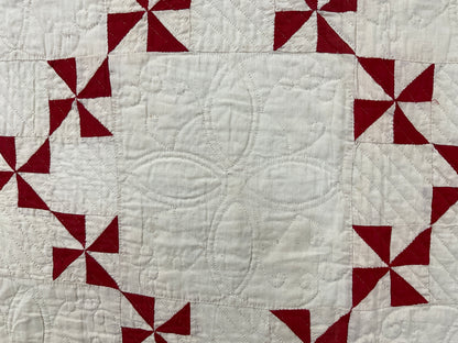 Red and cream pinwheel quilt