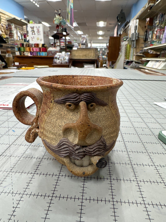 Vintage folk art “ugly face” pottery mug